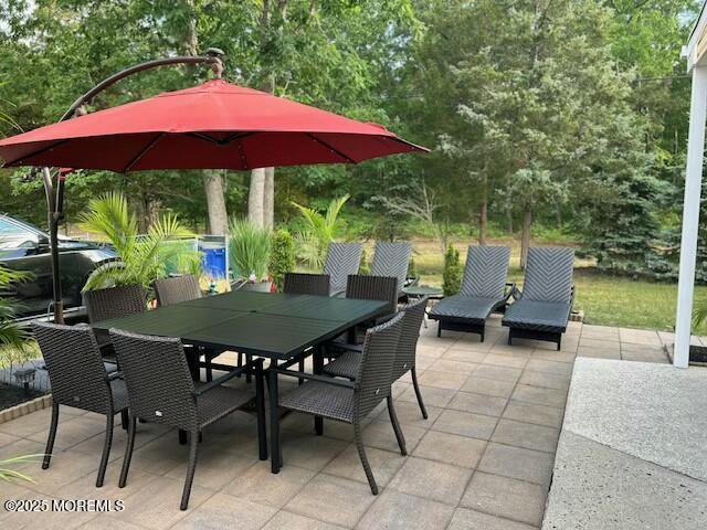 view of patio featuring outdoor dining area