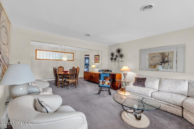 living area featuring a baseboard heating unit, carpet, and visible vents