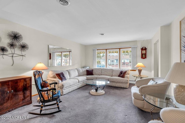 carpeted living area featuring a baseboard radiator, a healthy amount of sunlight, and visible vents