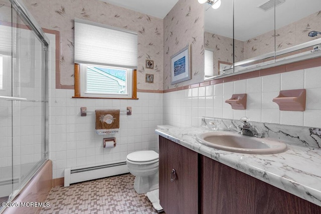 bathroom featuring tile walls, a baseboard radiator, visible vents, toilet, and wallpapered walls