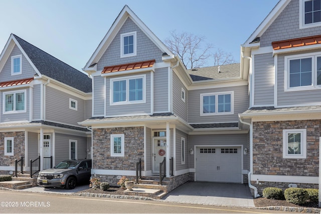 shingle-style home with an attached garage and a shingled roof