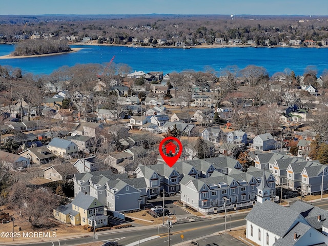 bird's eye view featuring a water view and a residential view