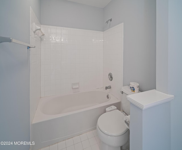 bathroom with toilet,  shower combination, and tile patterned floors