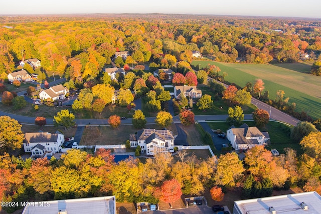 drone / aerial view with a wooded view