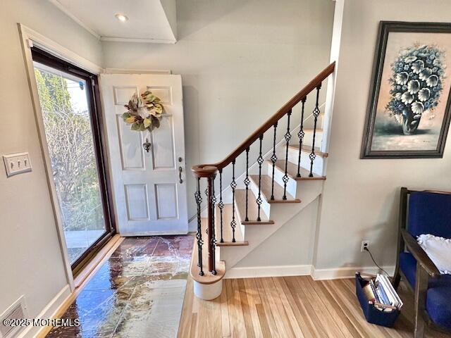 foyer with stairs, recessed lighting, baseboards, and wood finished floors