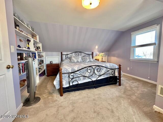 bedroom featuring carpet floors, vaulted ceiling, and baseboards