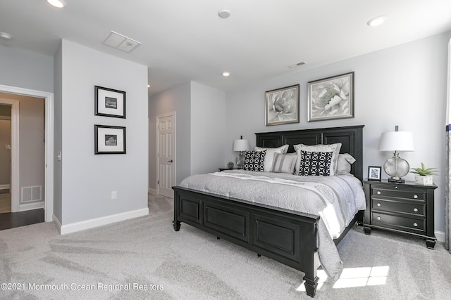 bedroom with light colored carpet, visible vents, baseboards, and recessed lighting