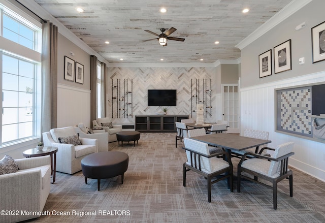 dining space with an accent wall, recessed lighting, and crown molding