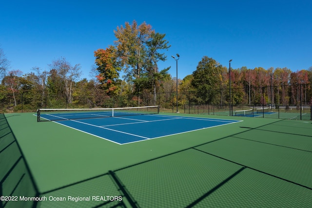 view of sport court featuring fence