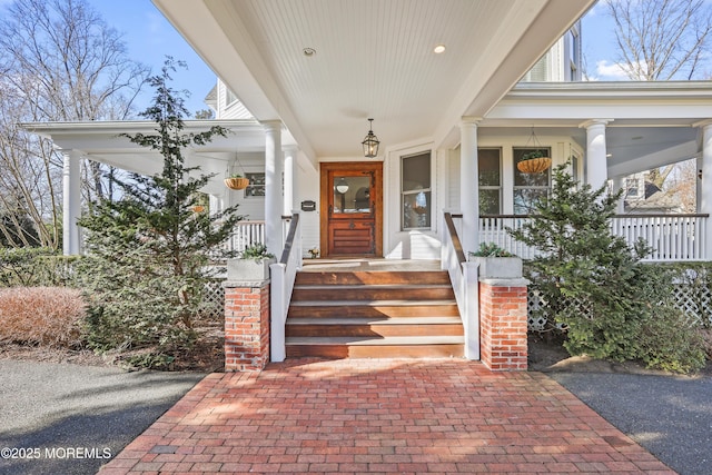 view of exterior entry with a porch