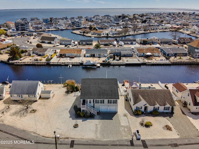 drone / aerial view with a water view and a residential view