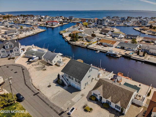 bird's eye view featuring a water view and a residential view