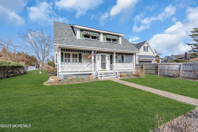 view of front facade featuring covered porch, roof with shingles, a front yard, and fence