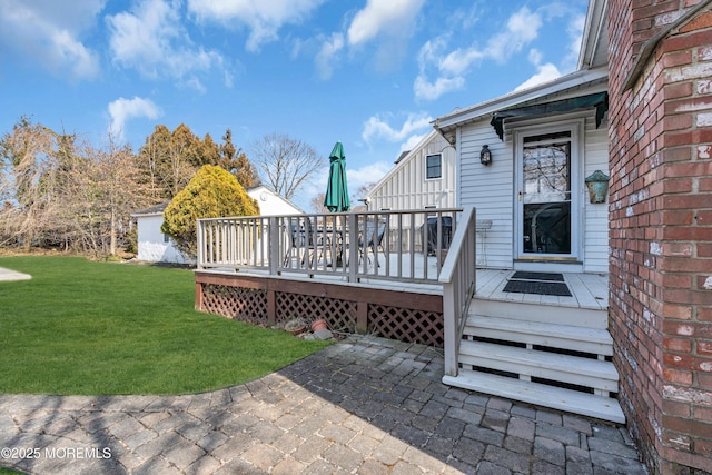 deck with a patio area and a yard