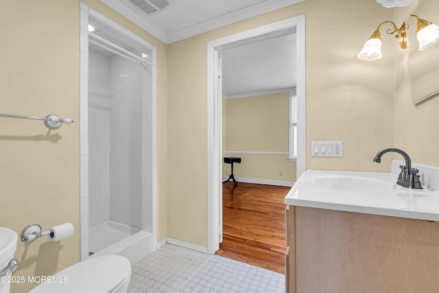 full bathroom with visible vents, toilet, a tile shower, crown molding, and vanity