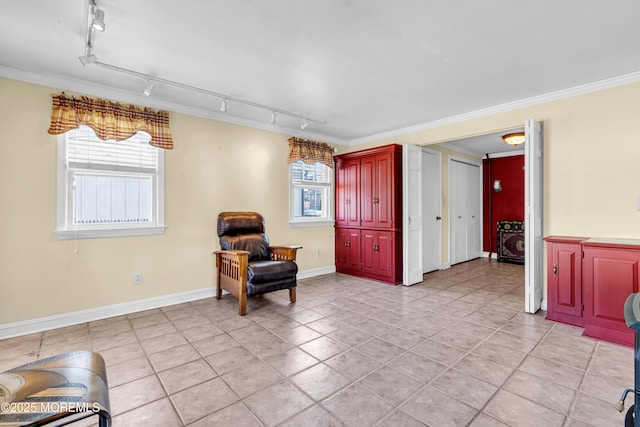 sitting room featuring plenty of natural light, baseboards, crown molding, and light tile patterned flooring