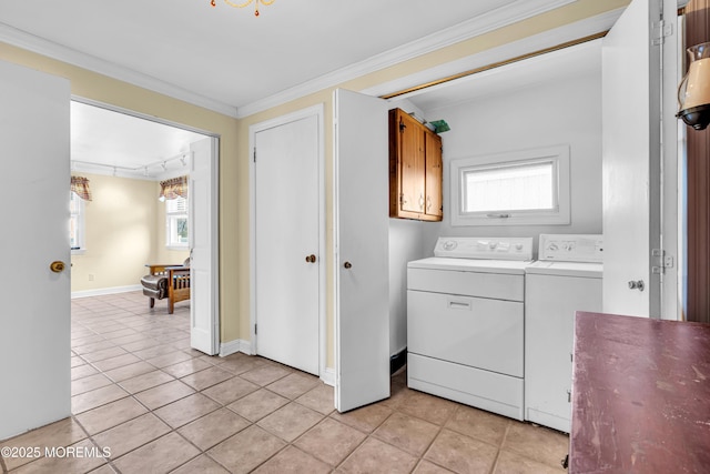 laundry area with laundry area, washing machine and dryer, light tile patterned floors, and ornamental molding