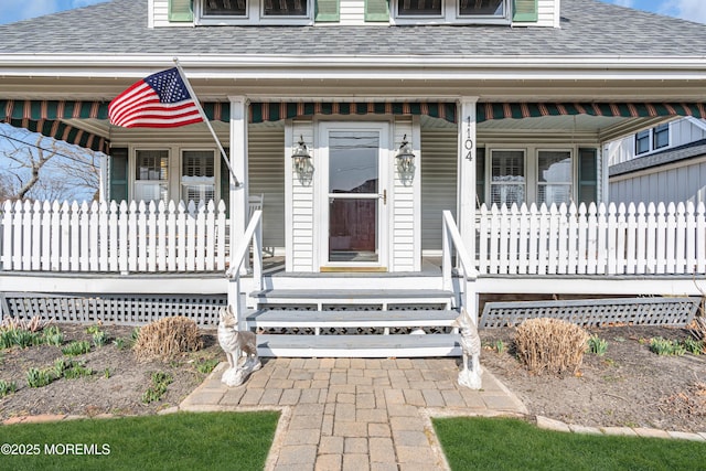 property entrance featuring a porch and a shingled roof