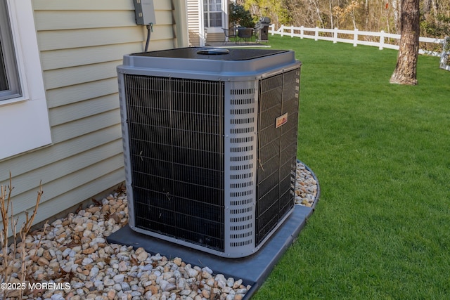 exterior details featuring central AC and fence