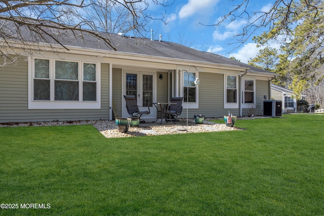 rear view of property featuring a yard and a patio