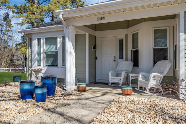 view of exterior entry featuring covered porch