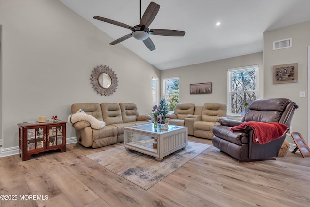 living room featuring visible vents, baseboards, ceiling fan, wood finished floors, and high vaulted ceiling