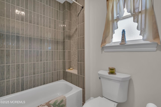 full bath with washtub / shower combination, plenty of natural light, and toilet