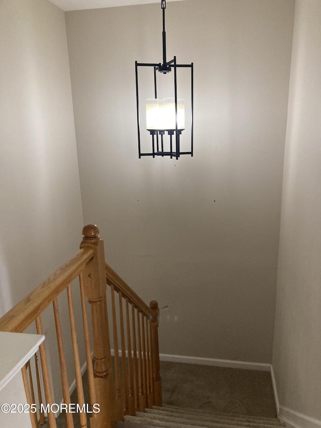 stairway featuring carpet flooring and baseboards