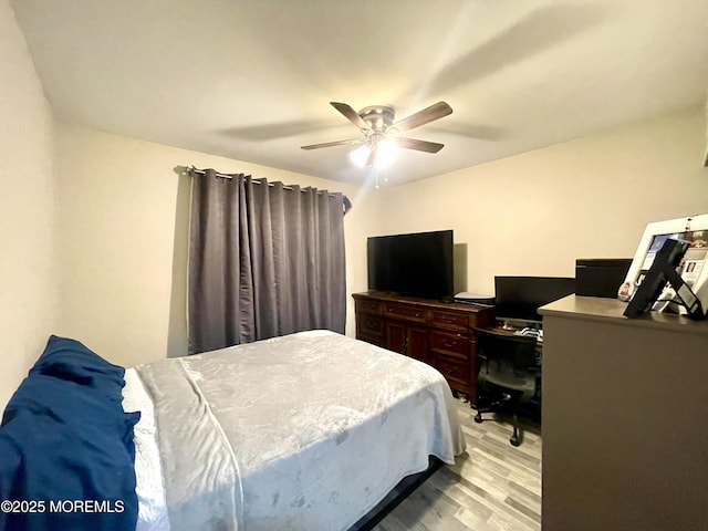 bedroom featuring light wood-type flooring and a ceiling fan