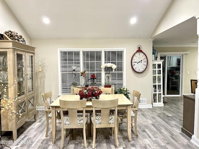 dining area featuring visible vents, recessed lighting, lofted ceiling, and wood finished floors