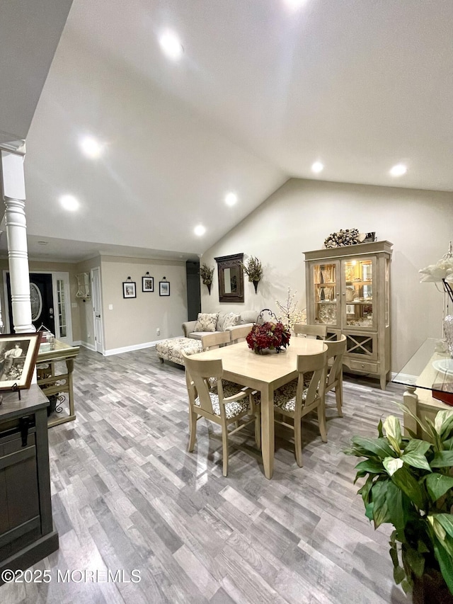 dining area featuring recessed lighting, baseboards, lofted ceiling, and wood finished floors