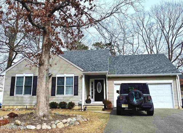 ranch-style house featuring aphalt driveway, a garage, and roof with shingles