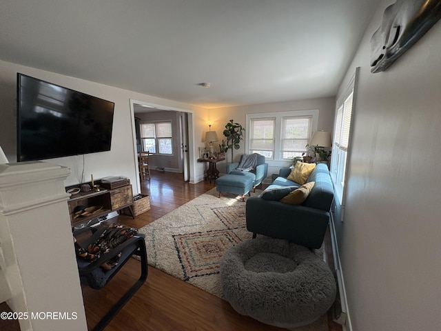 living area featuring baseboards and wood finished floors