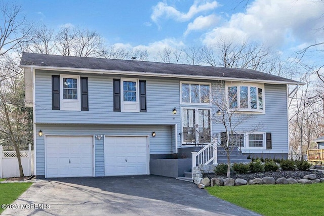 raised ranch featuring driveway and a garage