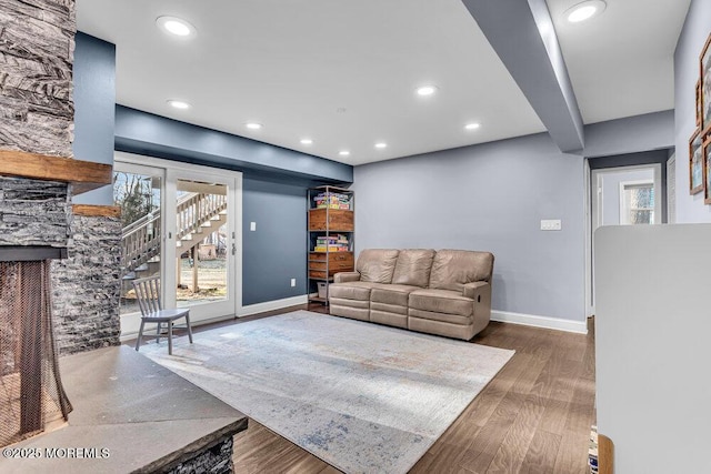 living room featuring stairs, recessed lighting, wood finished floors, and baseboards