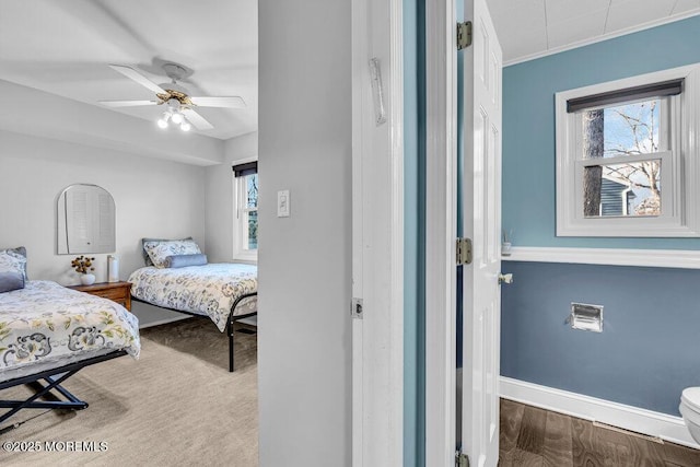 bedroom featuring a ceiling fan, baseboards, crown molding, and wood finished floors