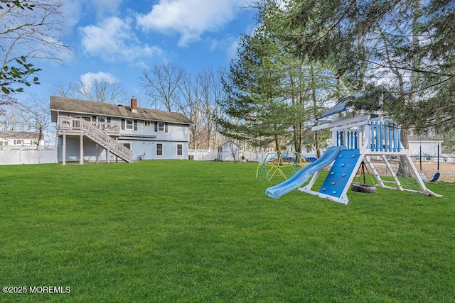 view of yard featuring stairway, a playground, and a fenced backyard