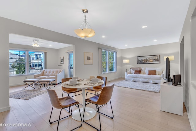 dining space featuring a ceiling fan, light wood-type flooring, baseboards, and recessed lighting