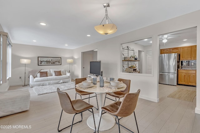 dining space featuring light wood-type flooring, baseboards, and recessed lighting