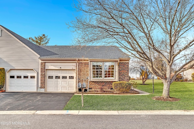 view of front of house featuring aphalt driveway, brick siding, an attached garage, and a front lawn