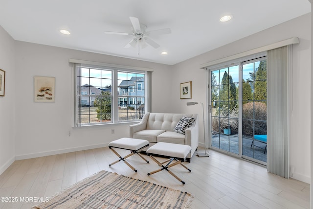 living area featuring light wood-style floors, ceiling fan, baseboards, and recessed lighting