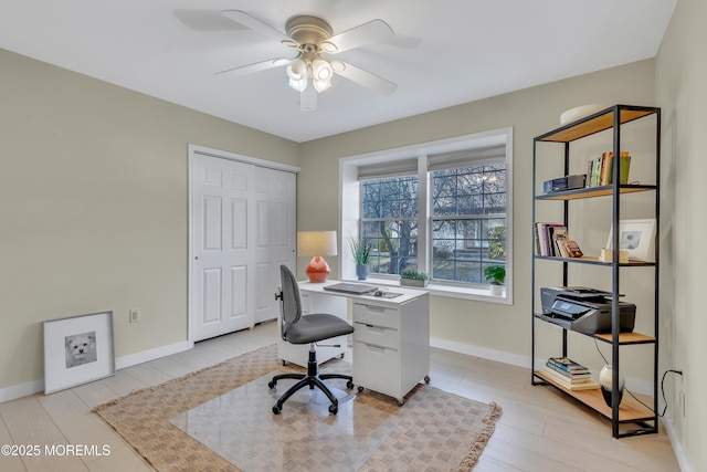 office space with ceiling fan, light wood finished floors, and baseboards