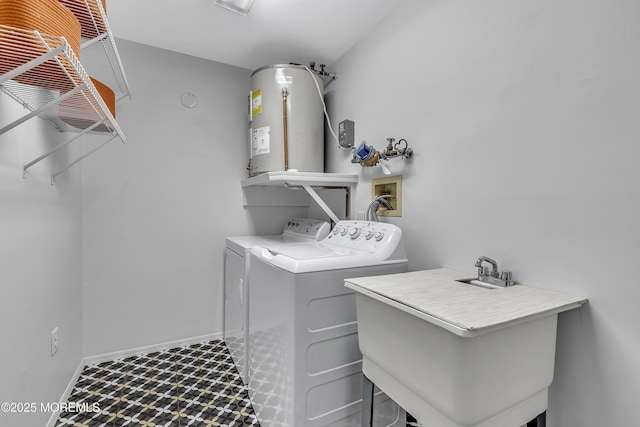 clothes washing area with gas water heater, laundry area, a sink, washer and dryer, and tile patterned floors