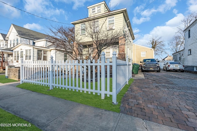 view of front of home with a fenced front yard and a residential view