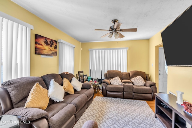 living room featuring ceiling fan and wood finished floors