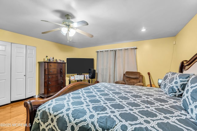 bedroom featuring a closet, ceiling fan, and wood finished floors