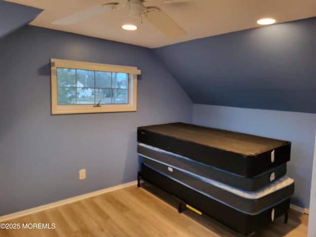 bedroom featuring lofted ceiling, recessed lighting, wood finished floors, and baseboards