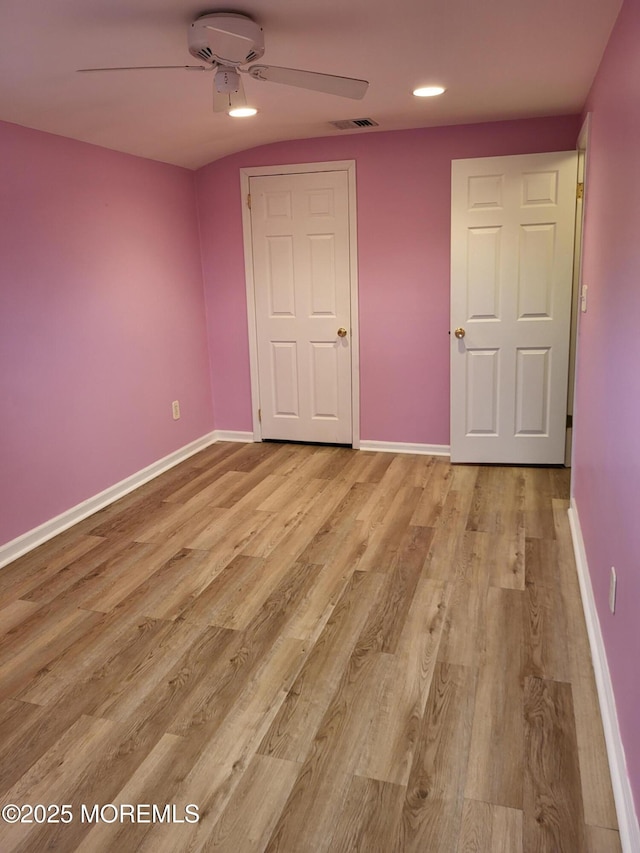 unfurnished bedroom featuring visible vents, light wood-style flooring, and baseboards