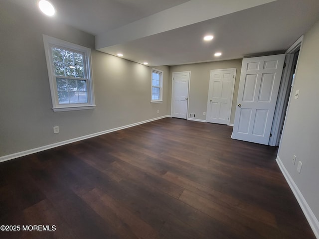 interior space with baseboards, dark wood-style flooring, and recessed lighting