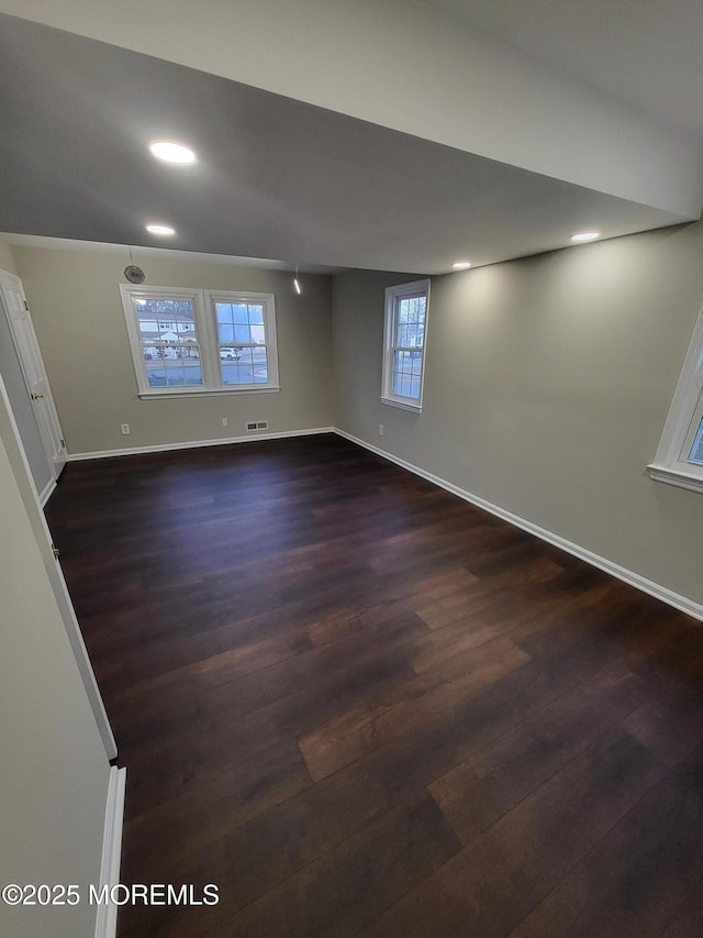 interior space with visible vents, baseboards, dark wood-style flooring, and recessed lighting